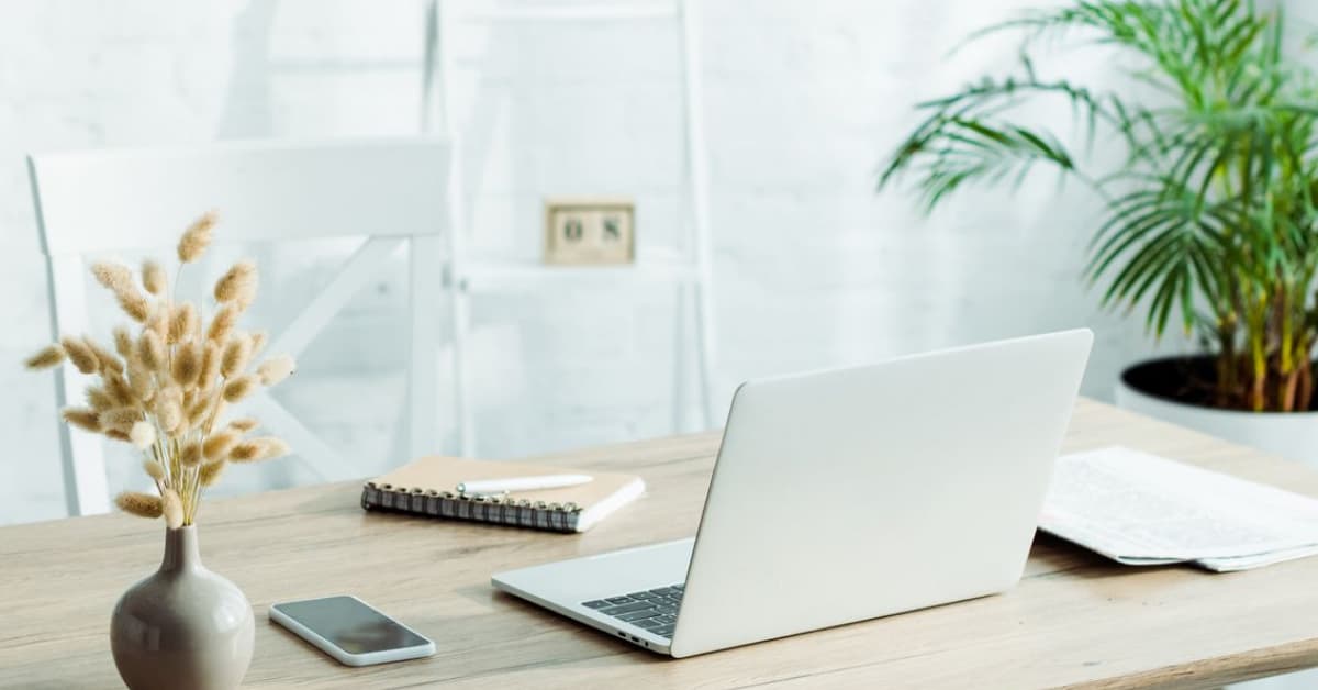 Laptop and notebook on a desk, ready for press release publishing